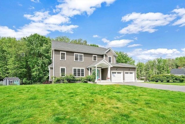 733 Monson Rd, Wilbraham, MA 01095 - view of front of house featuring driveway, a front yard, and an attached garage