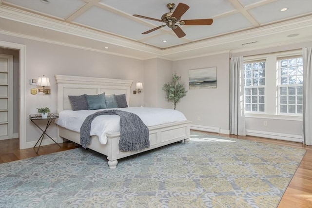 bedroom with wood-type flooring, a baseboard heating unit, ceiling fan, and crown molding