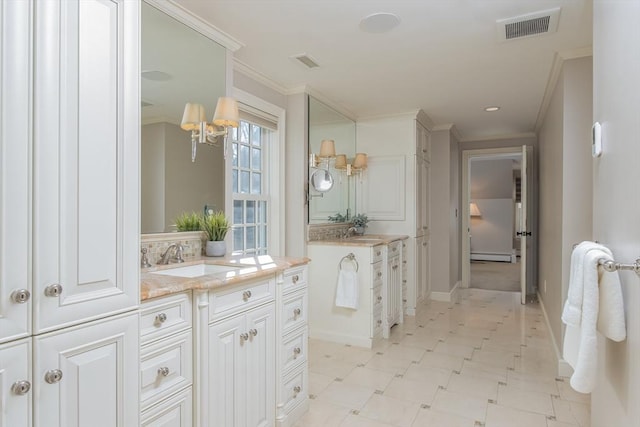 bathroom with a baseboard radiator, an inviting chandelier, crown molding, decorative backsplash, and vanity