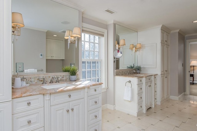 bathroom featuring vanity, tasteful backsplash, and ornamental molding