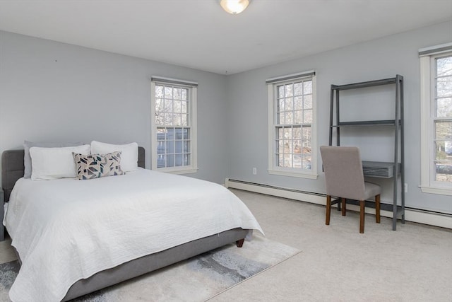 carpeted bedroom featuring a baseboard heating unit and multiple windows