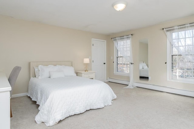 bedroom with light colored carpet and baseboard heating