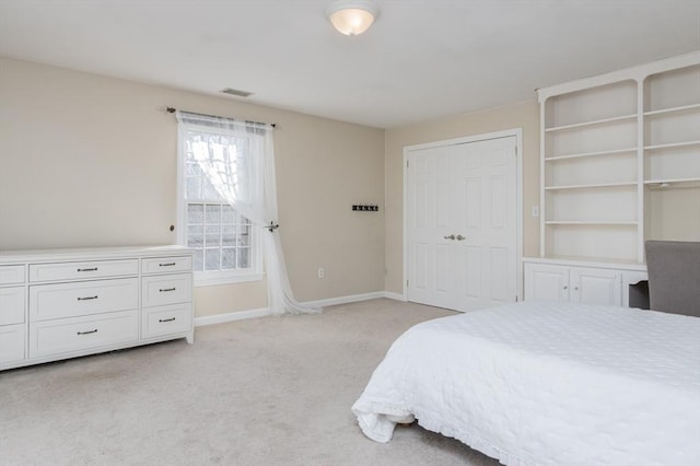 bedroom featuring light carpet and a closet