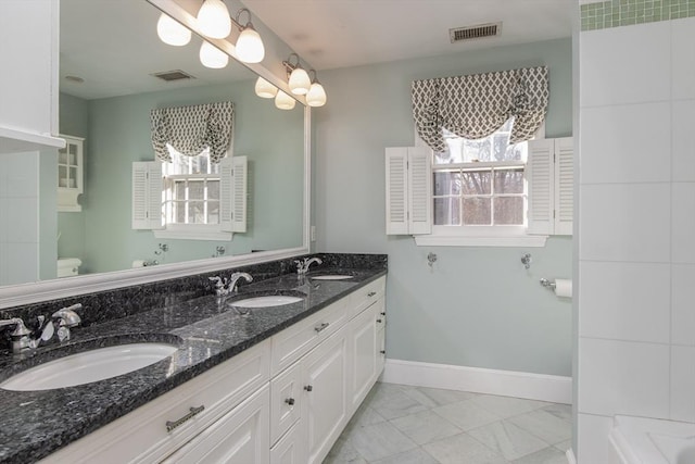 bathroom featuring vanity and toilet