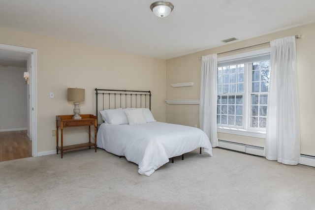 carpeted bedroom with baseboard heating