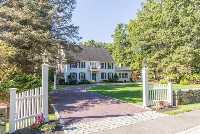 colonial-style house with a front lawn