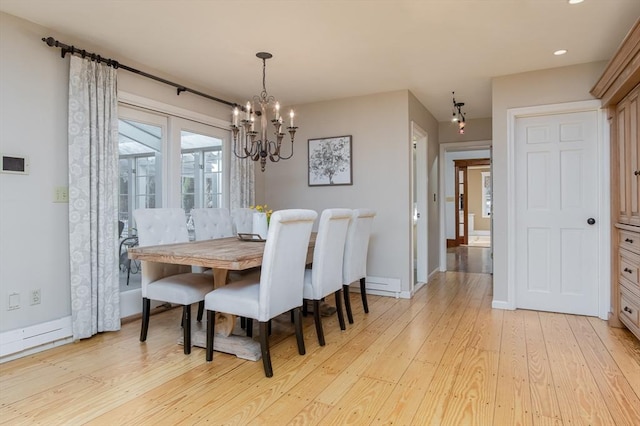 dining space featuring light hardwood / wood-style floors and a notable chandelier