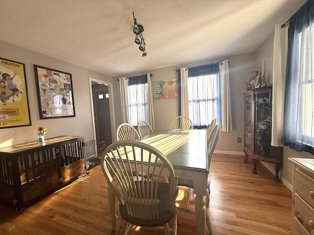 6 Gates St, Monson, MA 01057 - dining space with light wood-style floors, track lighting, and a textured ceiling