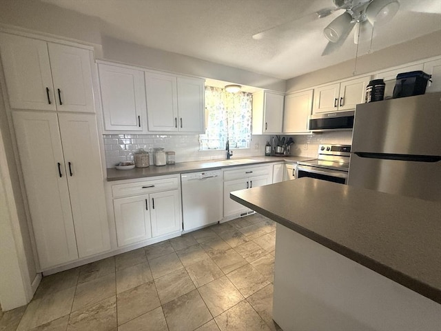 6 Gates St, Monson, MA 01057 - kitchen featuring stainless steel appliances, backsplash, white cabinets, and ceiling fan