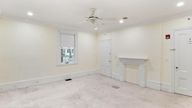 empty room featuring light carpet, ornamental molding, and visible vents