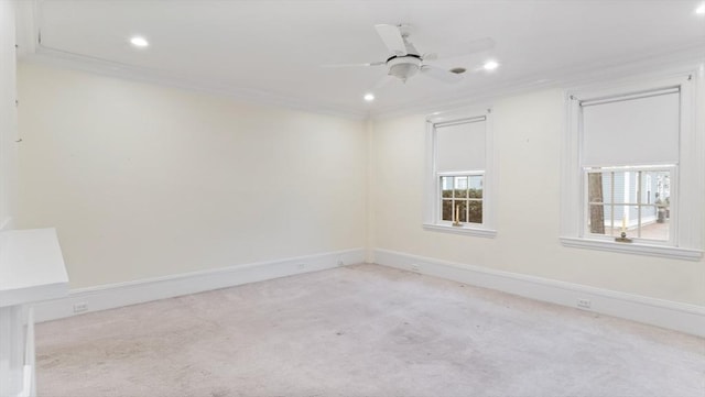 spare room featuring ceiling fan, recessed lighting, light colored carpet, baseboards, and ornamental molding