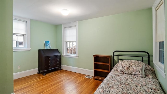 bedroom featuring wood finished floors and baseboards