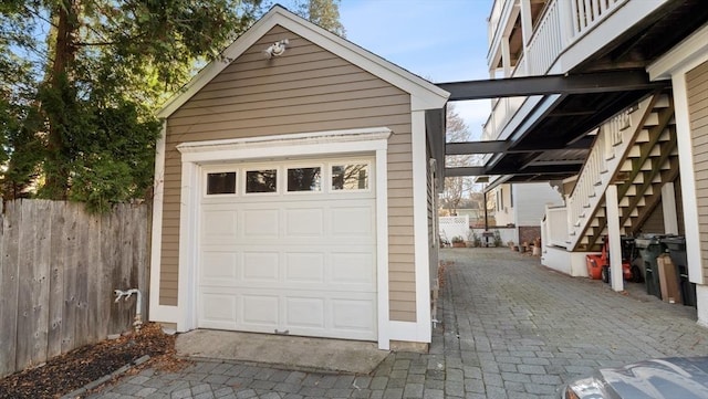 detached garage featuring fence