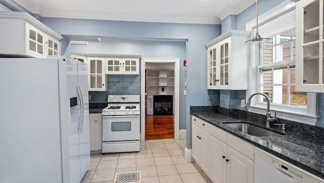 kitchen featuring crown molding, light tile patterned floors, white cabinetry, a sink, and white appliances