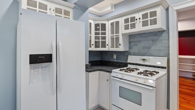 kitchen featuring glass insert cabinets, white appliances, white cabinetry, and decorative backsplash