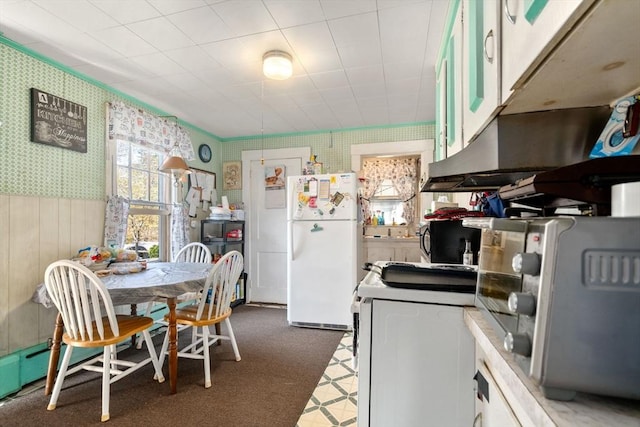 121 Purchase St, Milford, MA 01757 - kitchen featuring white appliances, wallpapered walls, wainscoting, white cabinets, and wooden walls