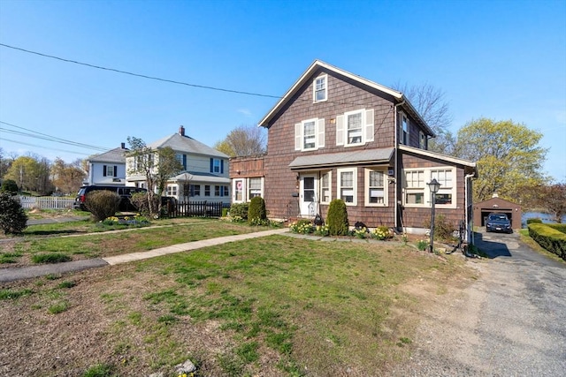 121 Purchase St, Milford, MA 01757 - view of front facade with driveway, an outbuilding, and a detached garage