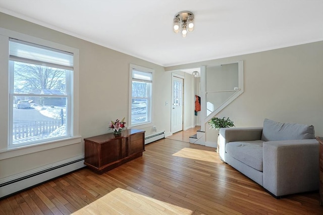 entryway featuring a baseboard radiator, wood-type flooring, and stairway