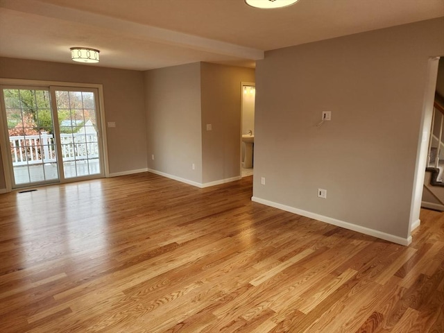 spare room featuring light hardwood / wood-style floors