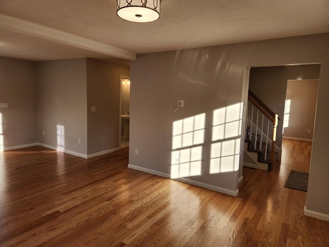 empty room with dark hardwood / wood-style flooring