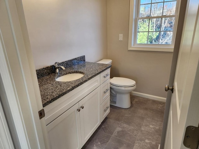 bathroom featuring toilet and vanity