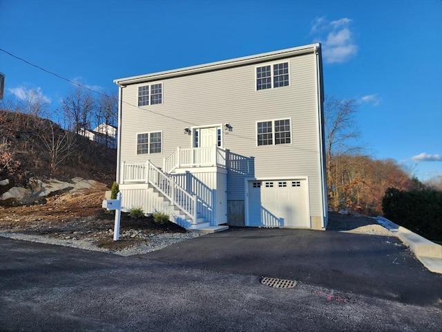 back of property with a garage