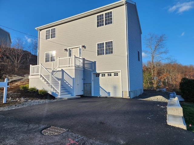 rear view of house featuring a garage