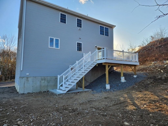 back of house featuring a wooden deck