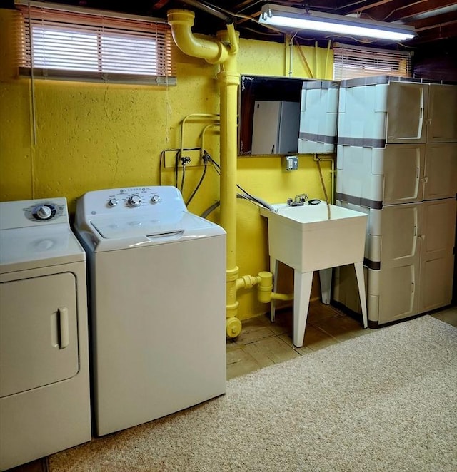 laundry room featuring light carpet and washing machine and clothes dryer