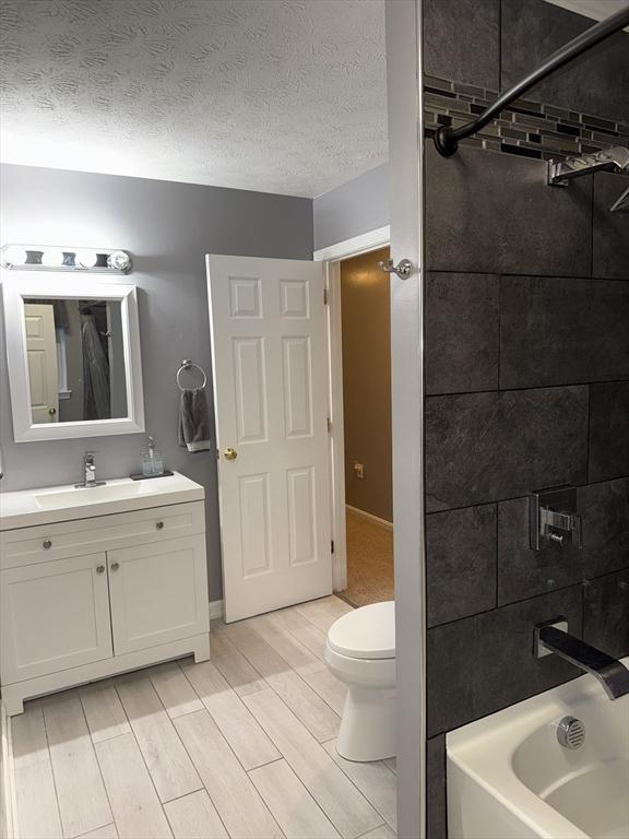 104 Orton St Unit 104, Worcester, MA 01604 - full bath with vanity, bathing tub / shower combination, toilet, and wood tiled floors