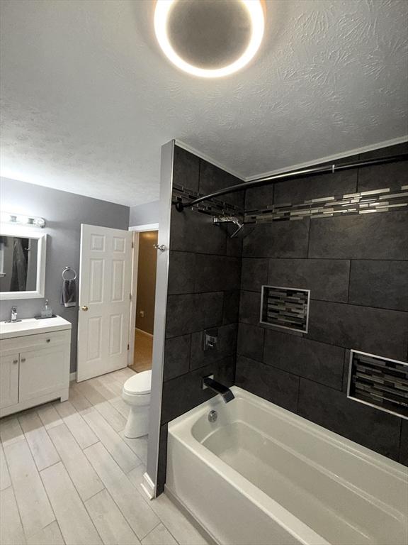 104 Orton St Unit 104, Worcester, MA 01604 - full bath with vanity, shower / washtub combination, toilet, and a textured ceiling