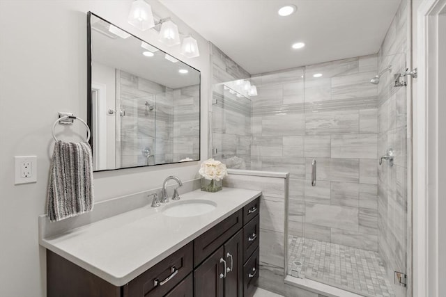 bathroom featuring recessed lighting, vanity, and a shower stall