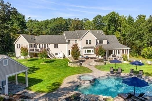 back of property featuring an outdoor fire pit, a patio area, a yard, and stairway