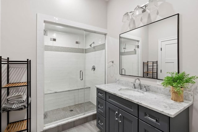 bathroom with a shower stall and vanity