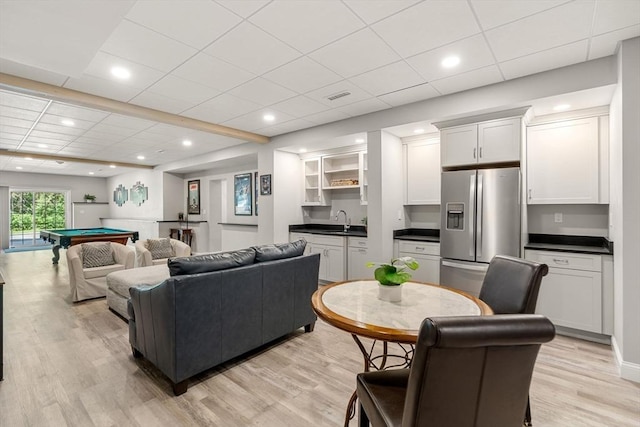 living room featuring light wood-type flooring, indoor wet bar, billiards, and recessed lighting