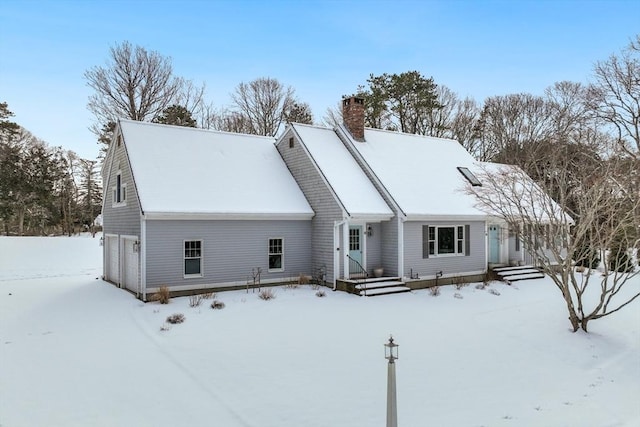 view of front facade with a garage and a chimney