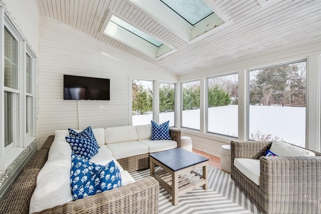 sunroom / solarium with vaulted ceiling with skylight