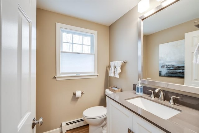 half bath with a baseboard radiator, vanity, toilet, and baseboards