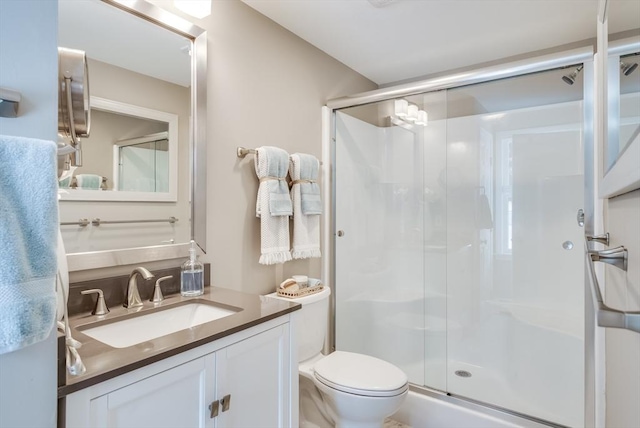 full bath with toilet, a shower stall, and vanity