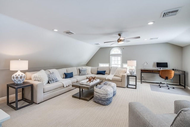 living room with light colored carpet, visible vents, and vaulted ceiling