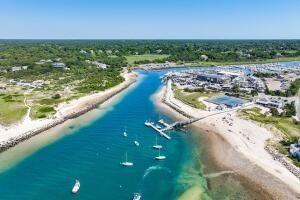 drone / aerial view featuring a water view and a beach view