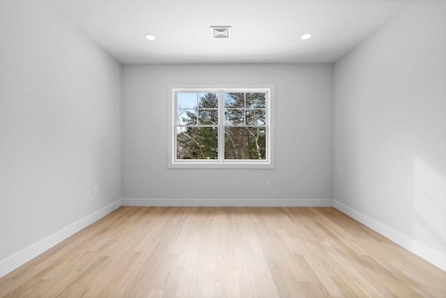 unfurnished room with light wood-type flooring