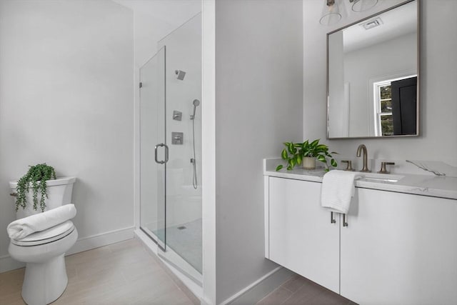 bathroom featuring toilet, a shower with door, and vanity