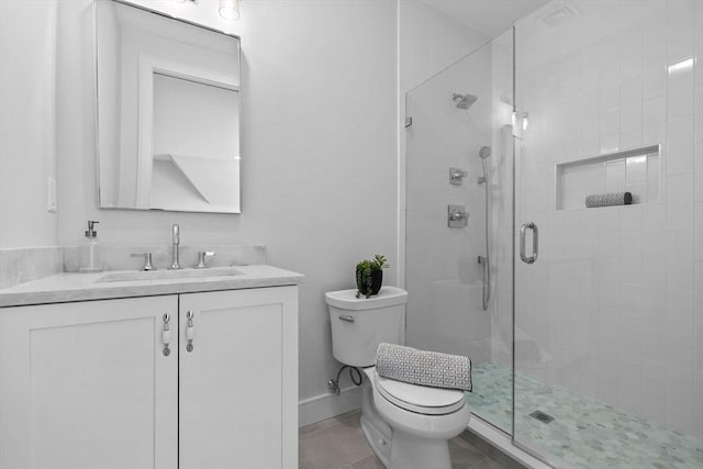 bathroom with toilet, an enclosed shower, tile patterned floors, and vanity