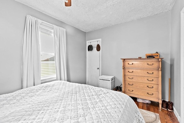 93 Warren, Fall River, MA 02721 - bedroom featuring dark wood finished floors, a textured ceiling, and ceiling fan