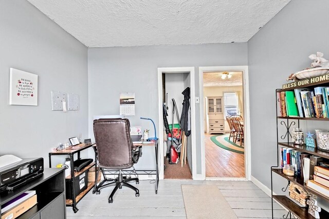 93 Warren, Fall River, MA 02721 - office space featuring a textured ceiling, wood finished floors, and baseboards
