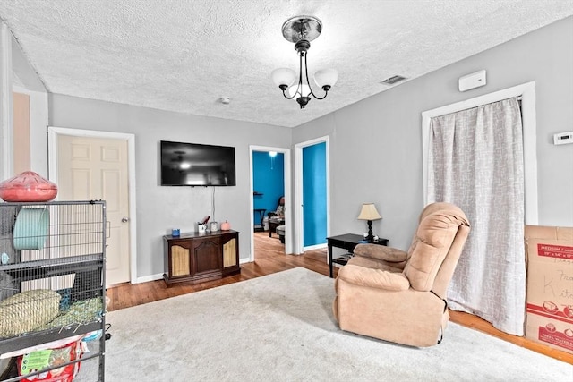 93 Warren, Fall River, MA 02721 - living area with wood finished floors, a textured ceiling, and baseboards