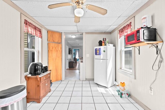 93 Warren, Fall River, MA 02721 - kitchen featuring freestanding refrigerator, brown cabinetry, ceiling fan, light countertops, and a paneled ceiling