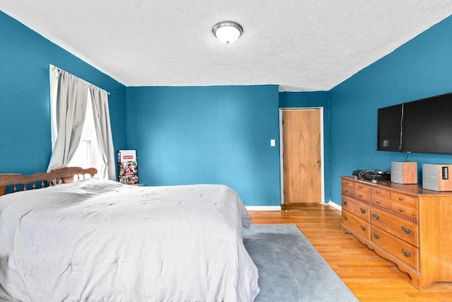 93 Warren, Fall River, MA 02721 - bedroom with light wood-type flooring, baseboards, and a textured ceiling