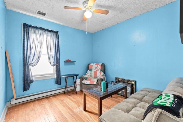 93 Warren, Fall River, MA 02721 - sitting room with a baseboard radiator, hardwood / wood-style flooring, ceiling fan, a textured ceiling, and baseboards